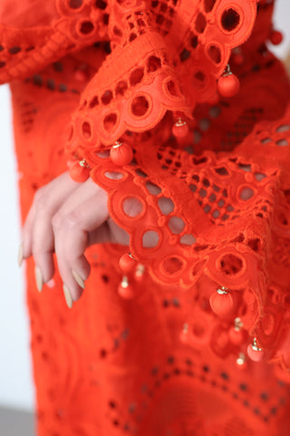 Brightside Palm red openwork-lace silk organza gown with high neck and dramatic sleeves, shown on model.