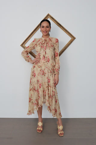 Model wearing Zimmermann floral midi dress in neutral tones with pink flowers, standing against a white background with a tilted gold frame.