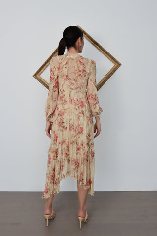 Model wearing Zimmermann floral midi dress in neutral tones with pink flowers, standing against a white background with a tilted gold frame.