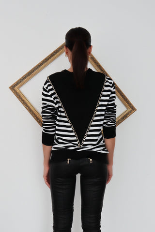 Balmain black and white striped pullover with chain detail.