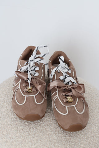 Naked Wolfe Adored sneakers in Mushroom suede, EU Size 40, featuring white contrast piping, oversized satin bow laces, logo-patterned laces, gold-tone hardware and chunky gum platform soles.